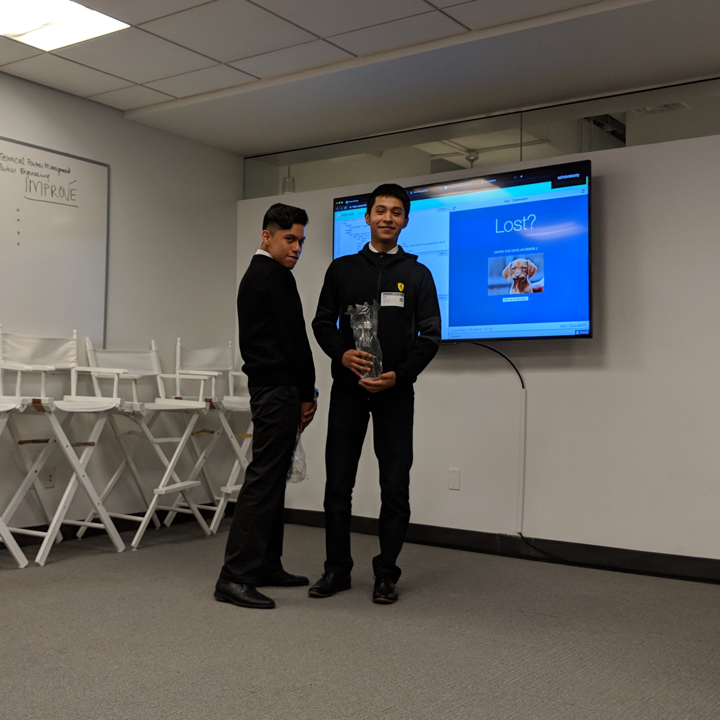 2 students posing with bottles