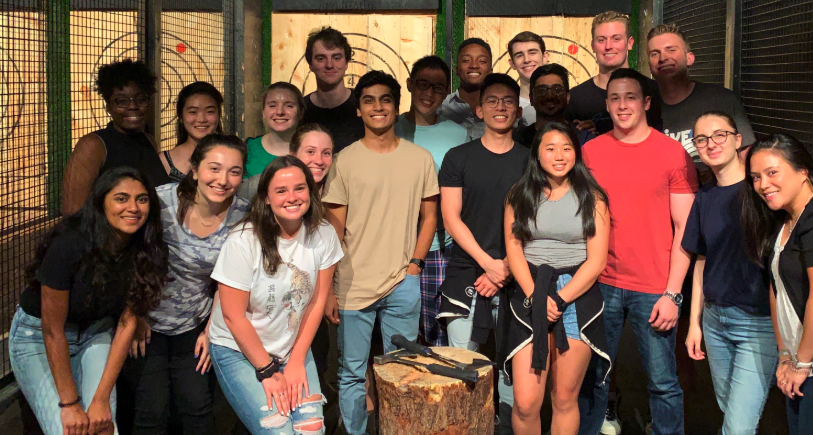 Interns at the axe-throwing bar